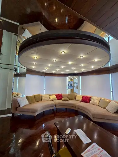 Luxurious living room with unique circular sofa and modern lighting
