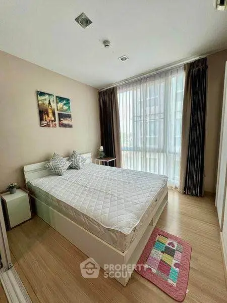 Cozy bedroom with large window and modern decor