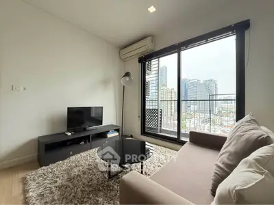 Modern living room with city view, featuring cozy sofa, TV, and large window for natural light.