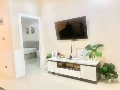 Modern living room with wall-mounted TV and stylish decor