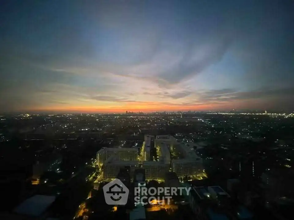 Stunning cityscape view at dusk with illuminated buildings and vibrant skyline.