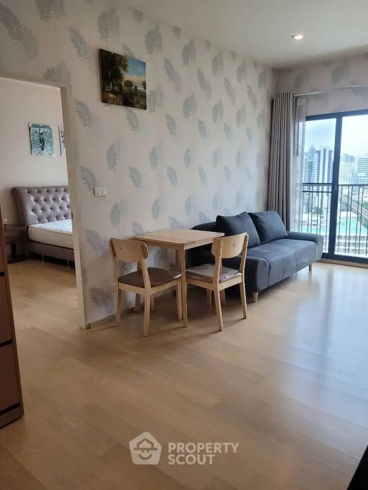 Modern living room with stylish decor and city view, featuring a cozy sofa and dining area.