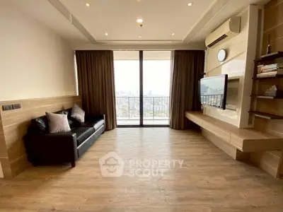 Spacious modern living room with city view, wooden flooring, and elegant decor.