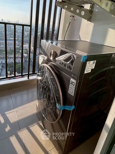 Modern washing machine on a high-rise balcony with city view, perfect for urban living convenience.