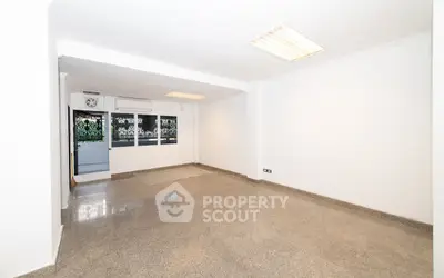 Spacious empty room with large windows and polished floor, ideal for customization.