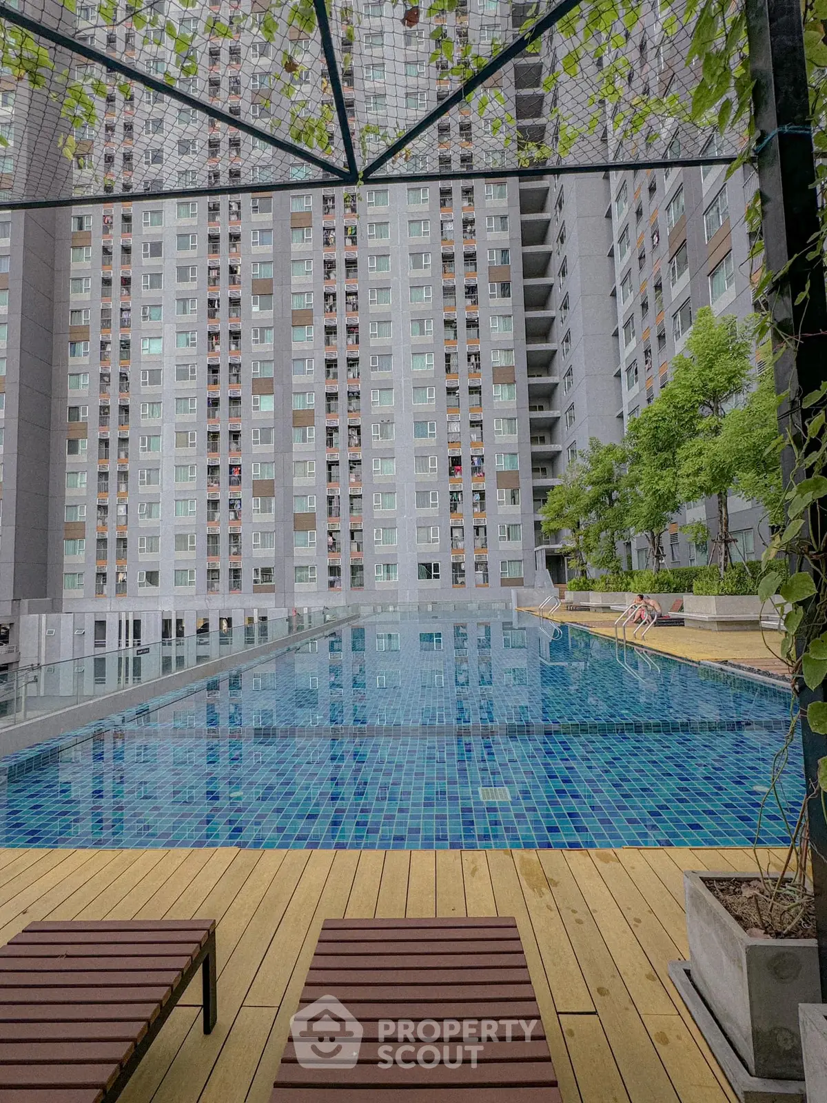 Luxurious apartment complex with stunning pool and modern architecture.