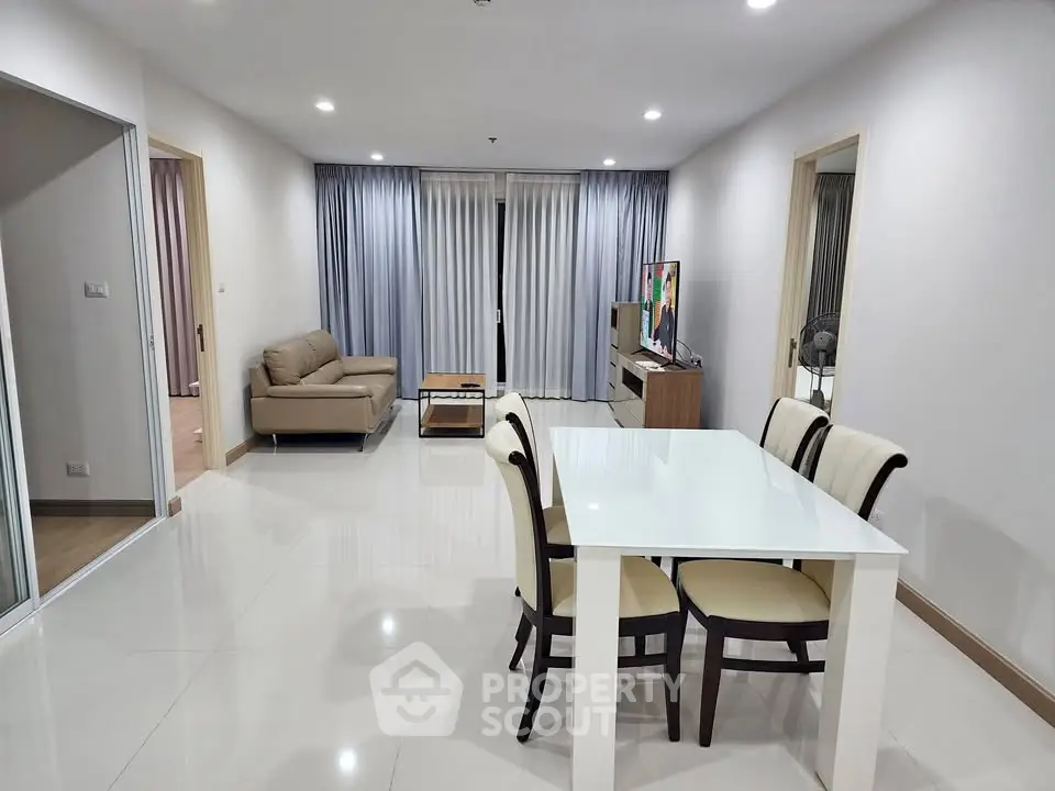 Spacious modern living room with dining area and elegant furnishings in a contemporary apartment.