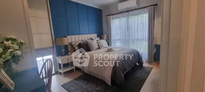 Elegant bedroom with modern decor and large window for natural light