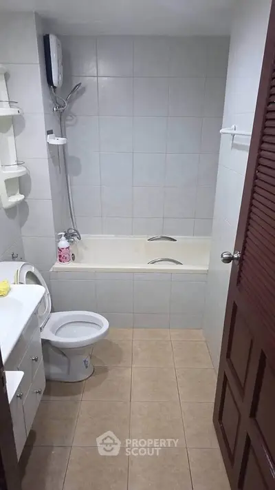 Cozy bathroom with bathtub and modern fixtures in a compact layout.