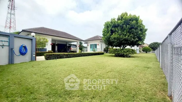 Spacious garden with modern house and lush greenery