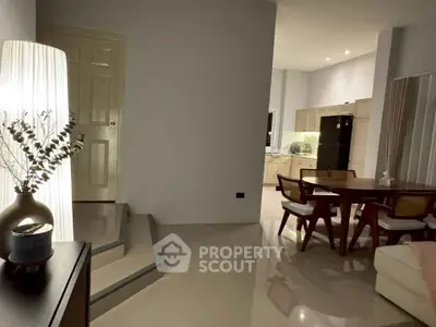 Elegant living room with modern dining area and stylish lighting