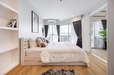 Spacious modern bedroom with elegant decor and natural light, featuring a cozy bed and stylish furnishings.
