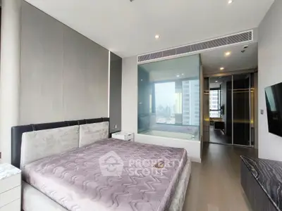Luxurious bedroom with modern design and city view, featuring a glass-enclosed bathtub.