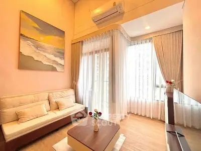 Elegant living room with large windows, cozy sofa, and modern decor in a high-rise apartment.
