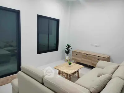 Modern living room with beige sofas and wooden furniture, perfect for cozy gatherings.