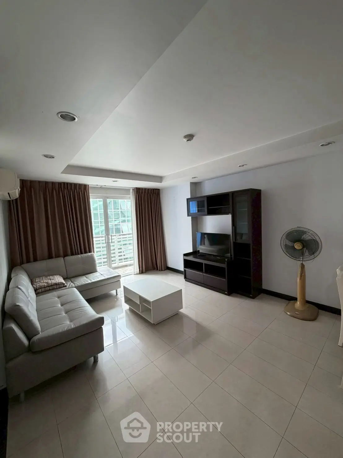 Spacious living room with modern furniture and large windows for natural light.