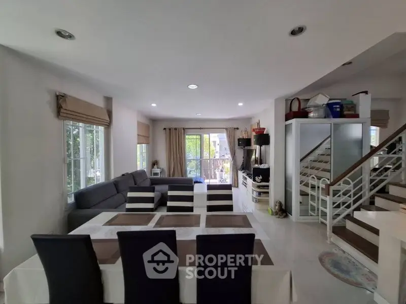 Spacious living room with modern decor and large windows for natural light.
