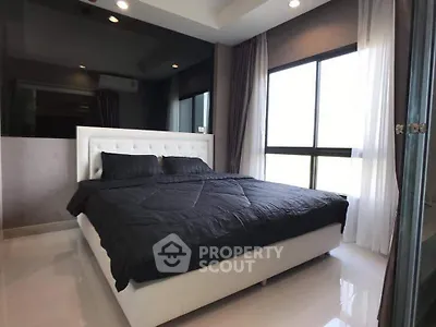 Modern bedroom with large window and stylish decor