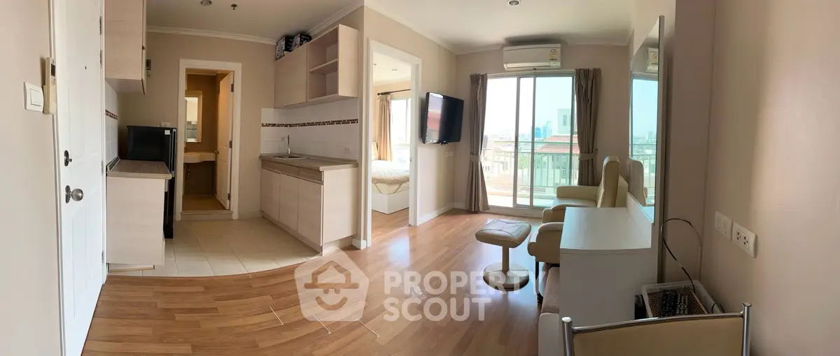 Modern open-plan living room with wooden flooring and balcony view