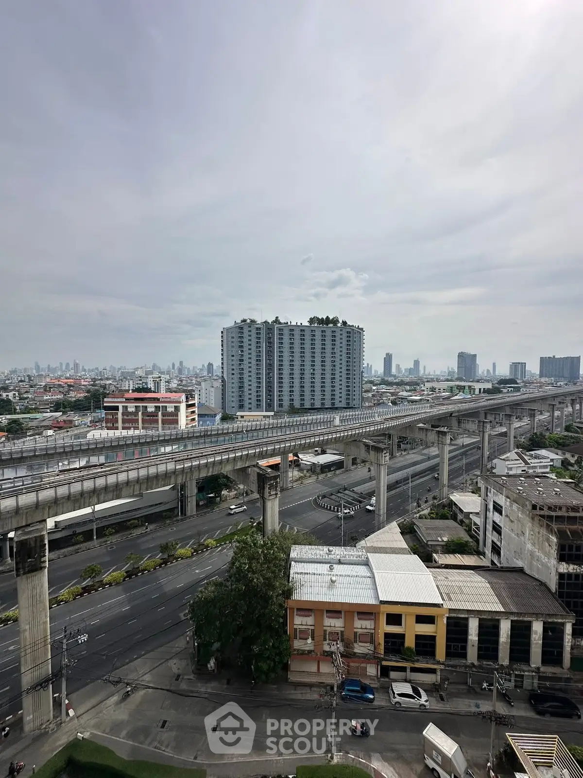 Stunning cityscape view with modern high-rise buildings and elevated train tracks.
