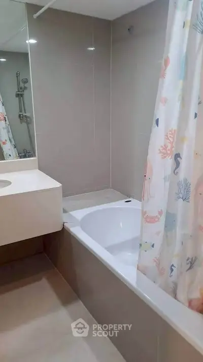Modern bathroom with bathtub and stylish shower curtain in a sleek, contemporary design.
