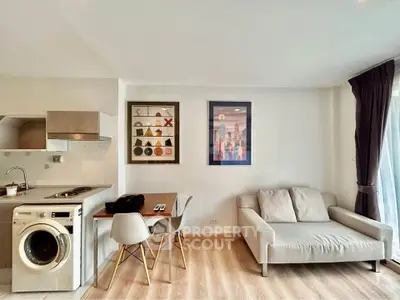 Modern living room with washing machine and stylish decor in a cozy apartment.