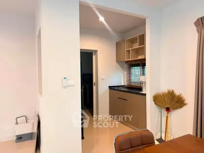 Modern kitchen with sleek cabinetry and open layout in a stylish home interior.