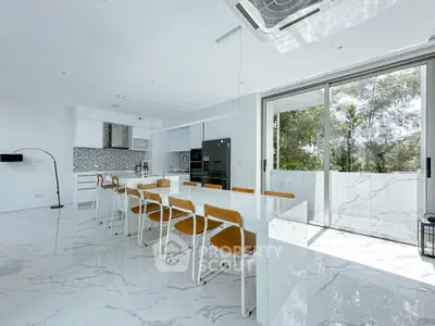 Spacious modern kitchen with open layout and large windows for natural light