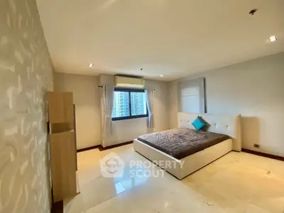 Spacious modern bedroom with large window and elegant decor