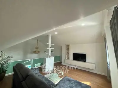 Chic attic living room with modern decor and cozy ambiance