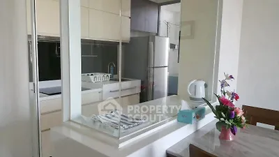 Modern kitchen with sleek design and open layout, featuring a dining area and stylish decor.