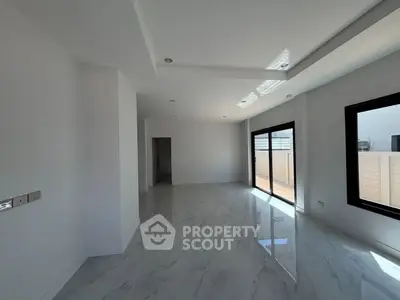 Spacious modern living room with large windows and sleek tile flooring