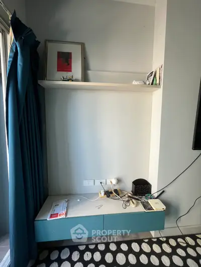 Modern interior with stylish shelf and blue curtains in a cozy living space.