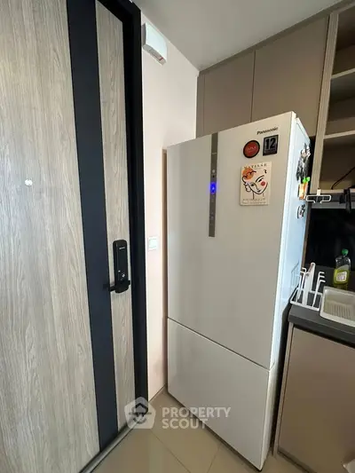 Modern kitchen with sleek refrigerator and stylish cabinetry