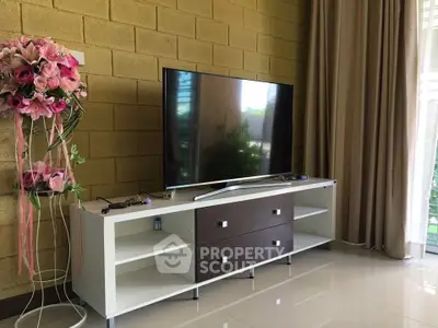 Modern living room with sleek TV stand and large flat-screen TV