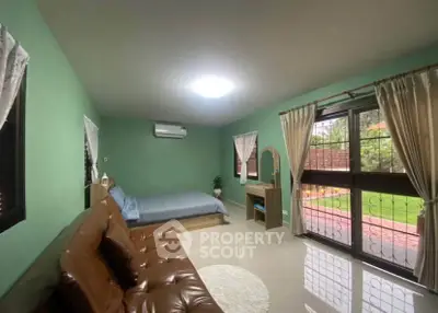 Spacious bedroom with garden view and modern furnishings