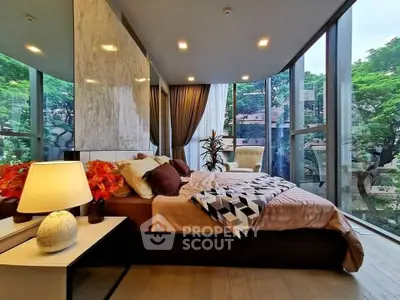 Luxurious bedroom with floor-to-ceiling windows and stunning garden view