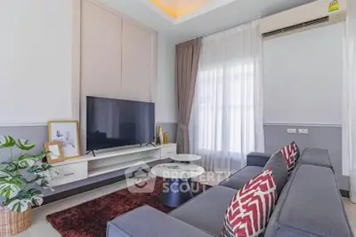 Modern living room with sleek furniture and large TV, perfect for relaxation and entertainment.
