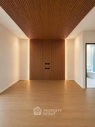 Modern minimalist room with wooden accents and recessed lighting, perfect for stylish living.