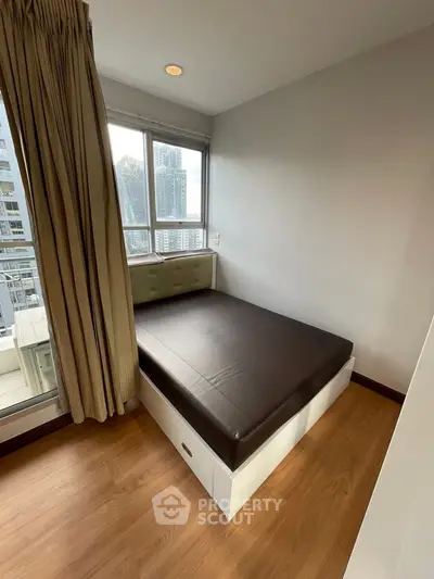 Cozy bedroom with city view and natural light in modern apartment