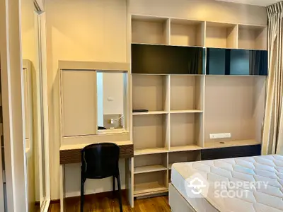 Modern bedroom with built-in shelving and stylish desk area