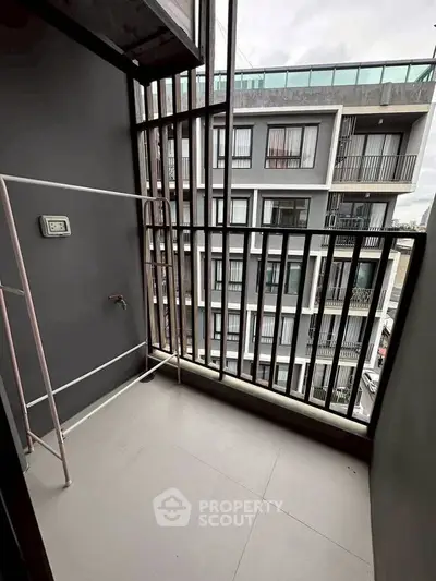 Modern apartment balcony with sleek railing and city view