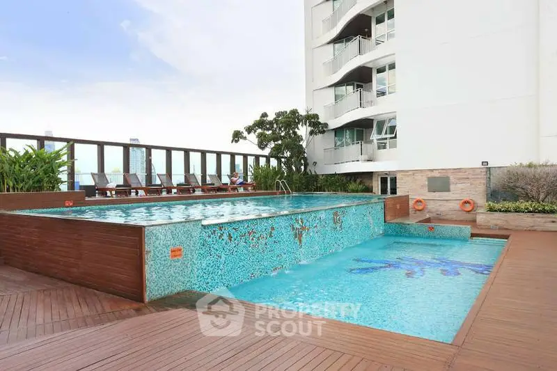 Luxurious rooftop pool with modern design and city views in a high-rise building.
