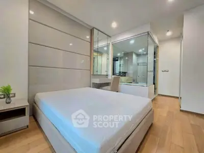 Modern bedroom with sleek design and glass partition in luxury apartment.