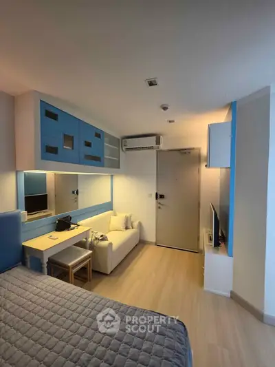 Modern studio apartment with stylish blue accents and cozy furnishings