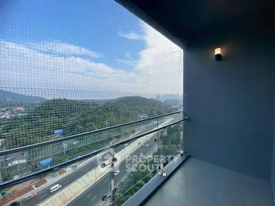 Stunning balcony with panoramic view of lush hills and highway below