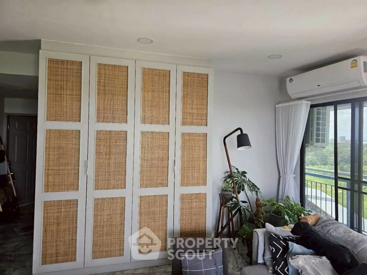 Stylish living room with woven cabinet and balcony view