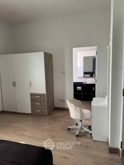 Modern bedroom with sleek furniture and wooden flooring