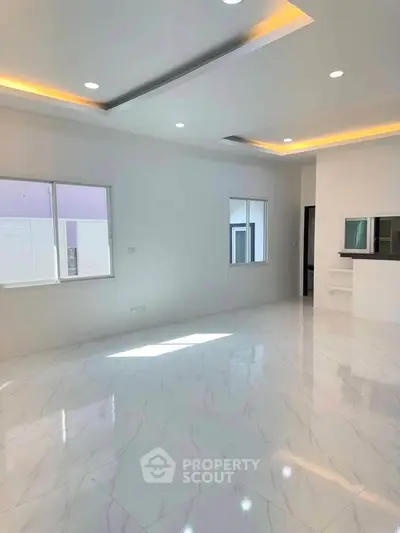 Spacious modern living room with elegant lighting and marble flooring