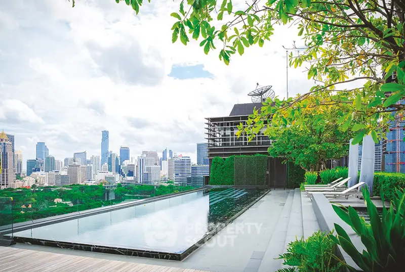 Luxurious rooftop pool with stunning city skyline view and lush greenery.